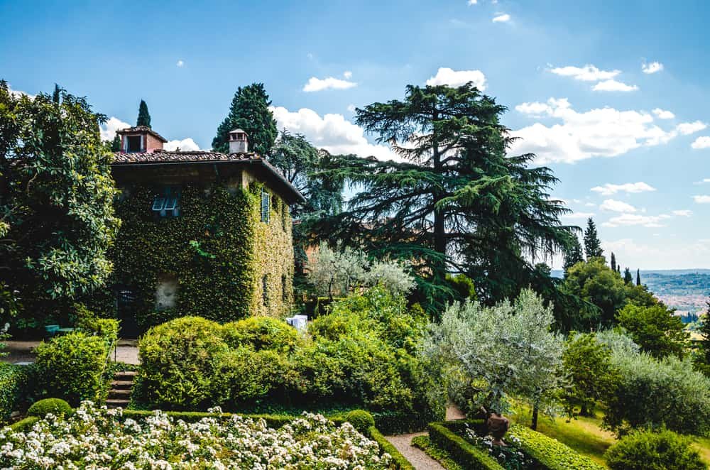 romantic things to do in florence - iconic image looking over the Italian city of Florence. the orange topped Duomo is visible and mountains in the distance